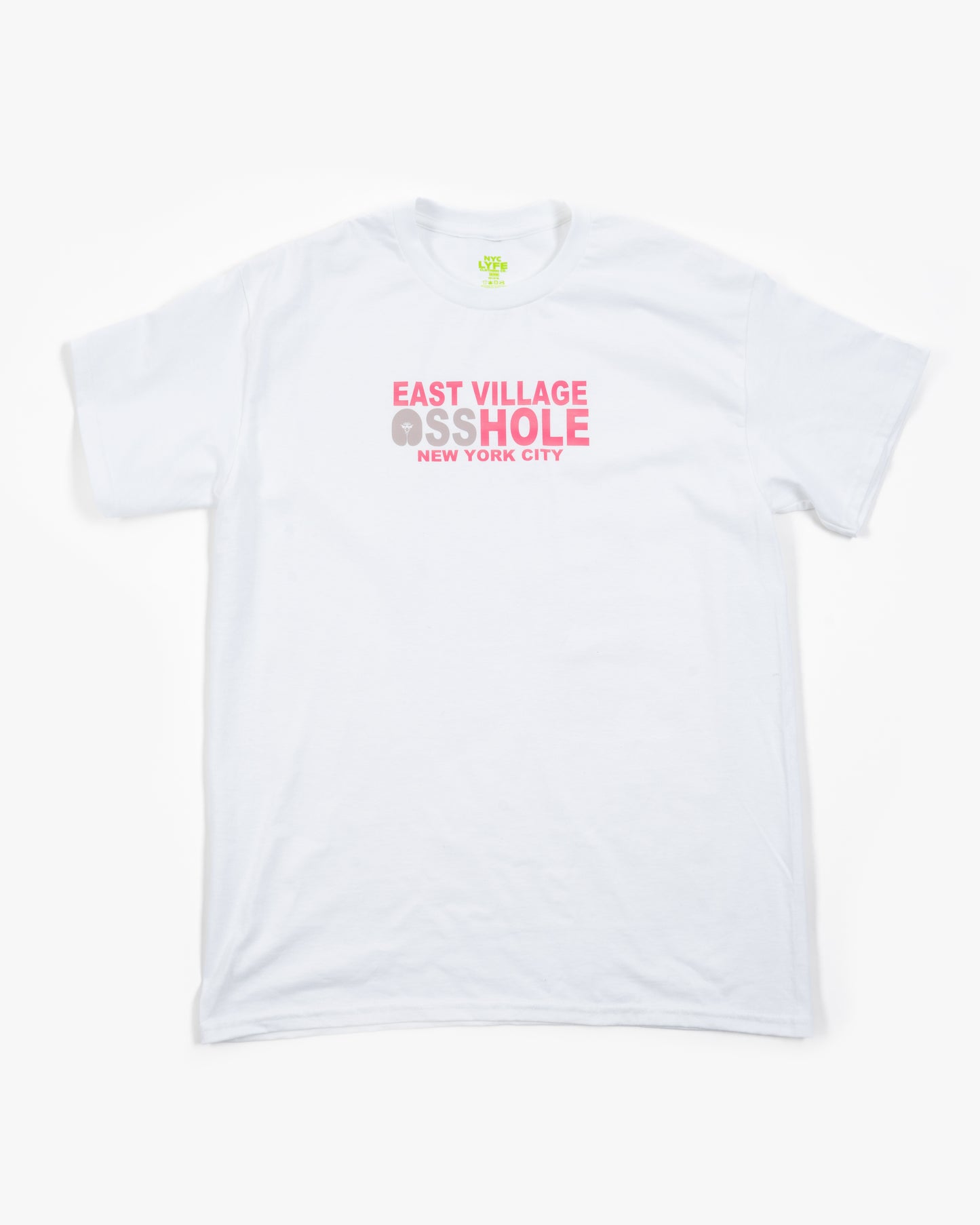 A white t-shirt laid flat, with the words 'EAST VILLAGE ASSHOLE' printed in pink on the chest. The 'O' in 'ASSHOLE' is replaced with a stylized graphic of a butt.
