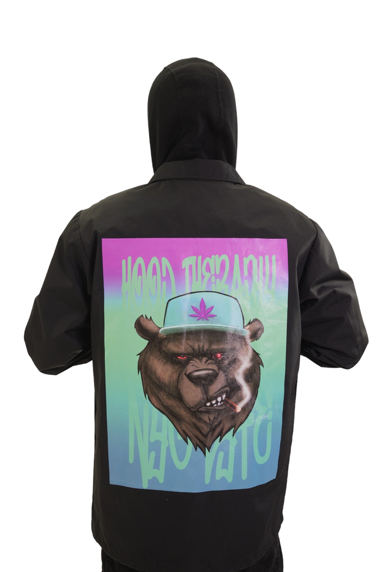 Back view of a black coach's jacket with a large, colorful graphic. The art features a snarling bear wearing a hat with a cannabis leaf, with the graffiti text 'HOOD THERAPY' above it.