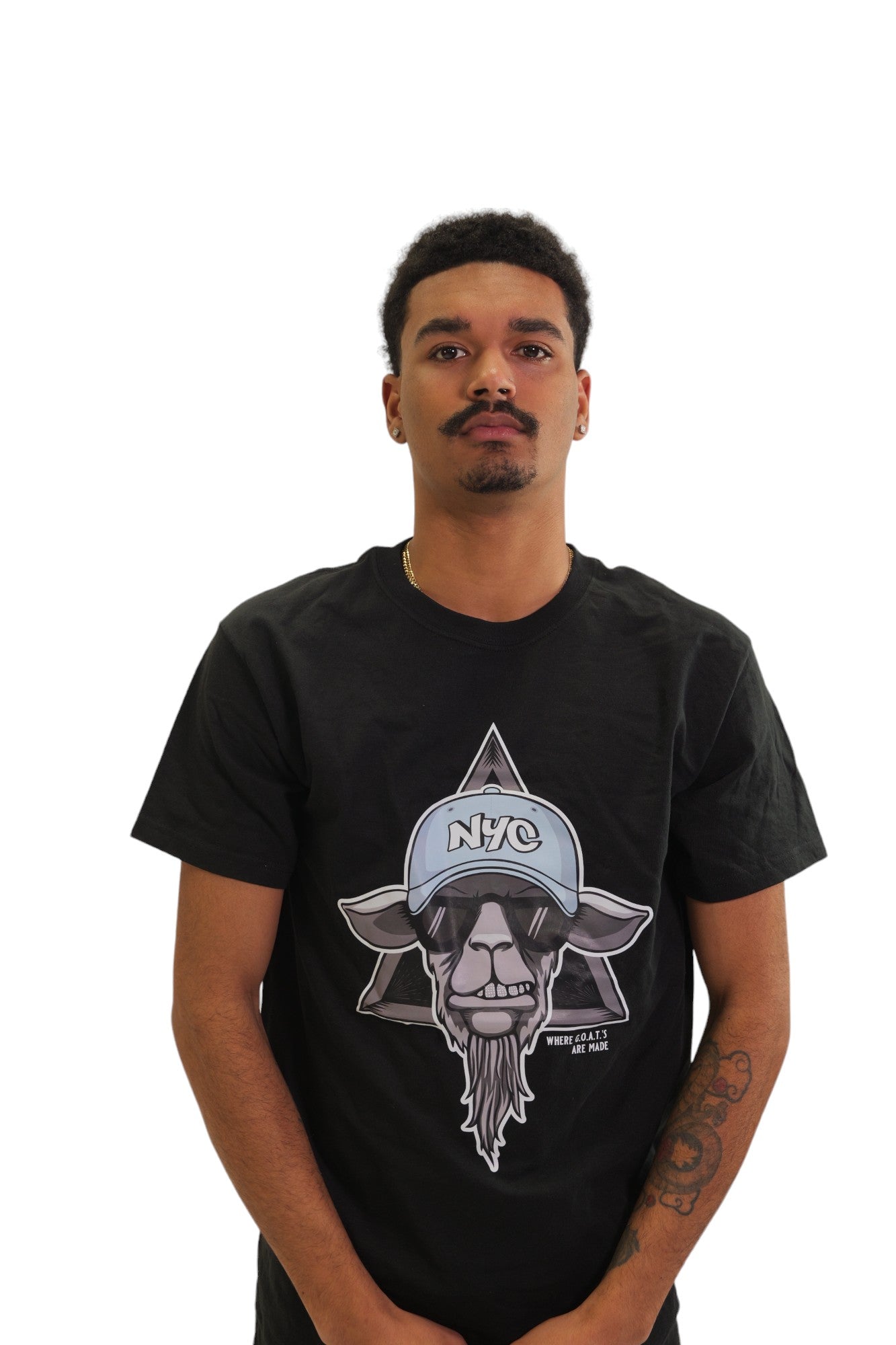 A model wearing a black t-shirt with a large graphic on the chest. The graphic features a cool-looking goat wearing sunglasses.