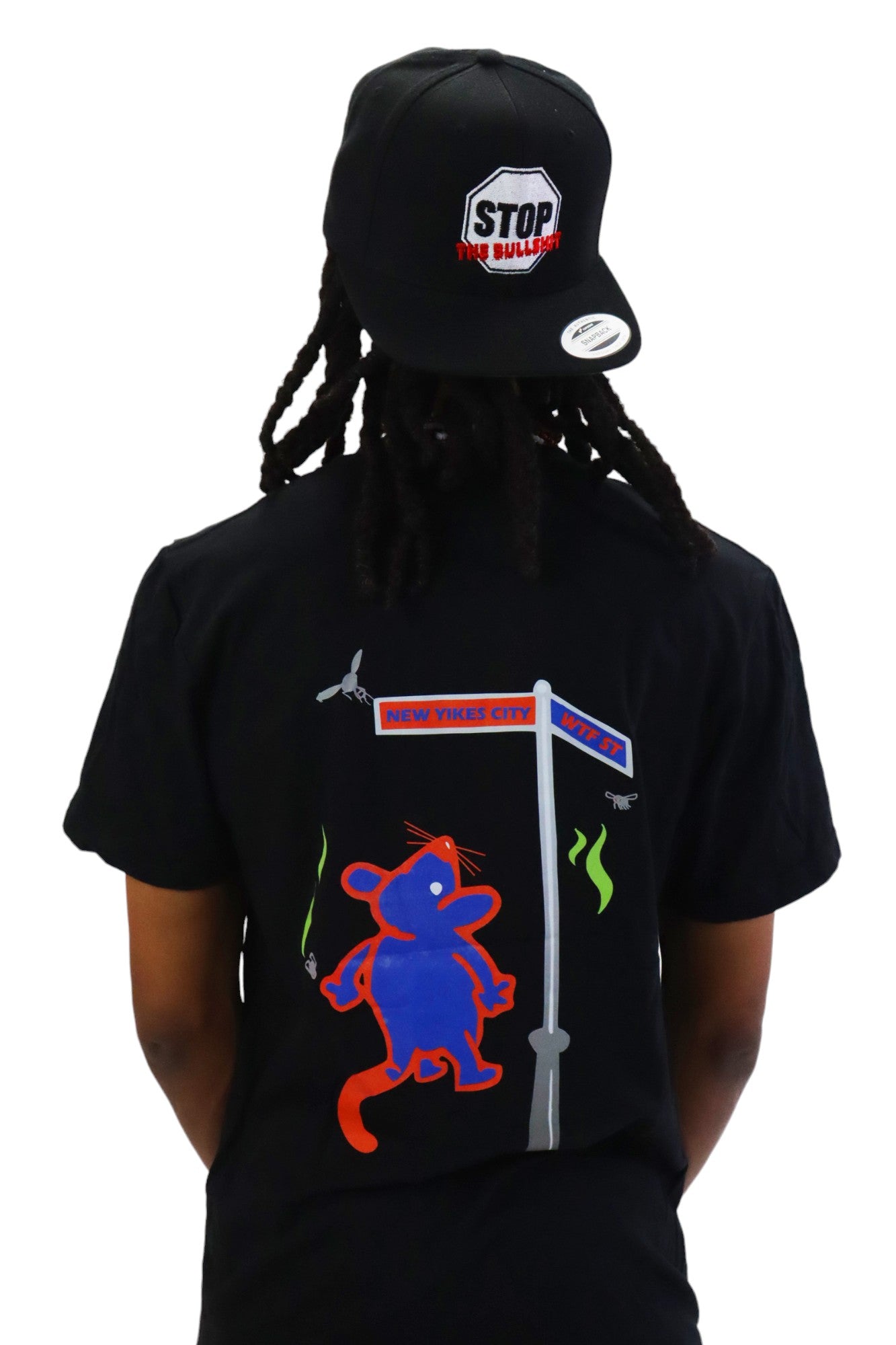 Back view of a model wearing a black t-shirt. The back has a cartoon graphic of a blue and red rat standing at a street sign for 'New Yikes City' and 'WTF ST'.