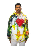 Model wearing a multi-colored ice-dye hoodie with a large, 3D puff-print 'I ❤️ NY' graphic on the front. The red heart has a textured, brick-like pattern.