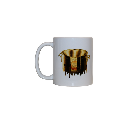 Front view of a white ceramic mug. The mug has a graphic of a large pot from which liquid gold is melting and dripping down.
