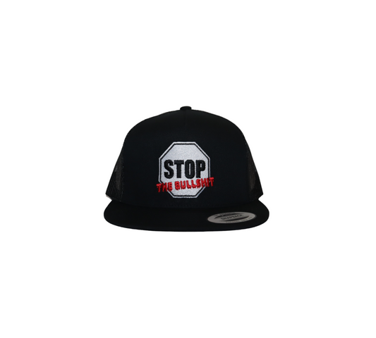 A black trucker hat with a white octagonal patch on the front designed like a stop sign. The patch reads 'STOP THE BULLSHIT' in black and red text.