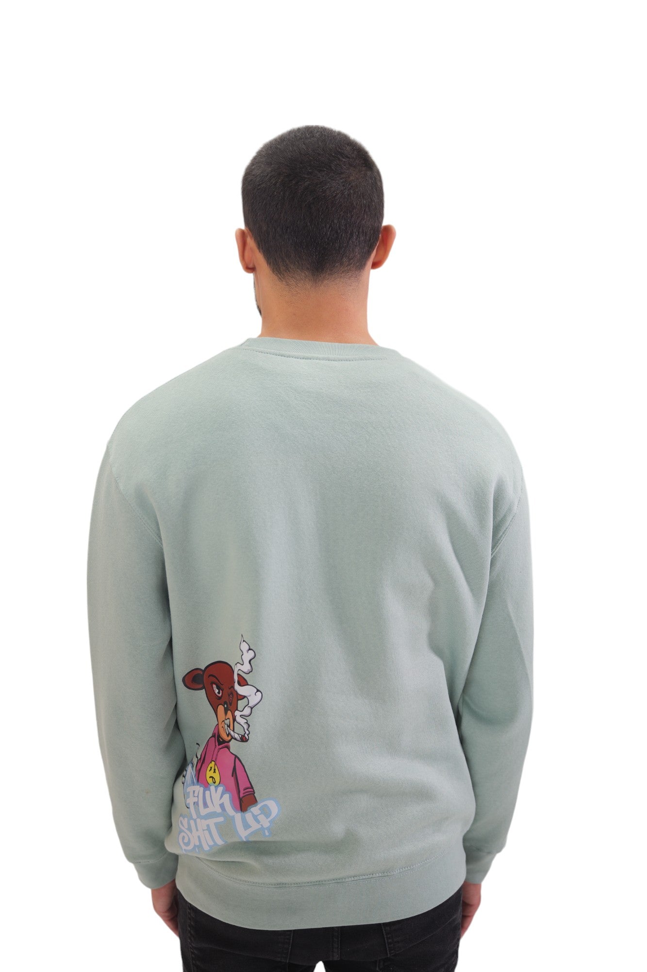 Back view of a model wearing a light blue crewneck sweatshirt. On the lower-left back is a small graphic of a cartoon bear and the words 'FUCK SHIT UP' in a graffiti-style font.
