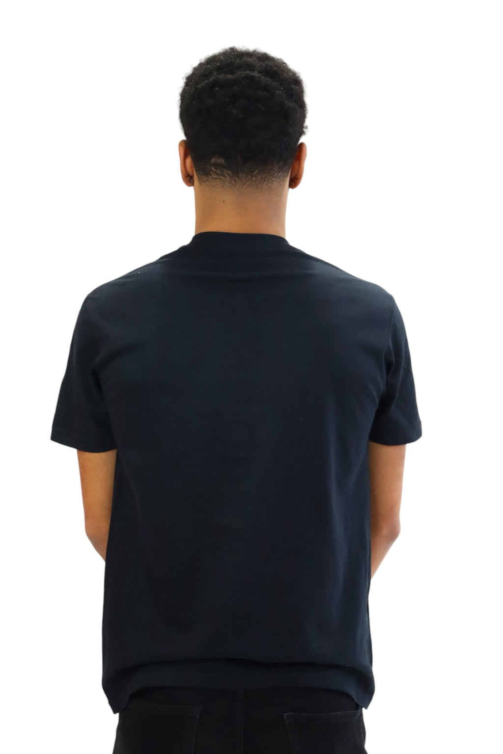 A man models a black t-shirt featuring a detailed graphic of a vintage New York City subway train in the front. The entire back of the T-shirt is black.