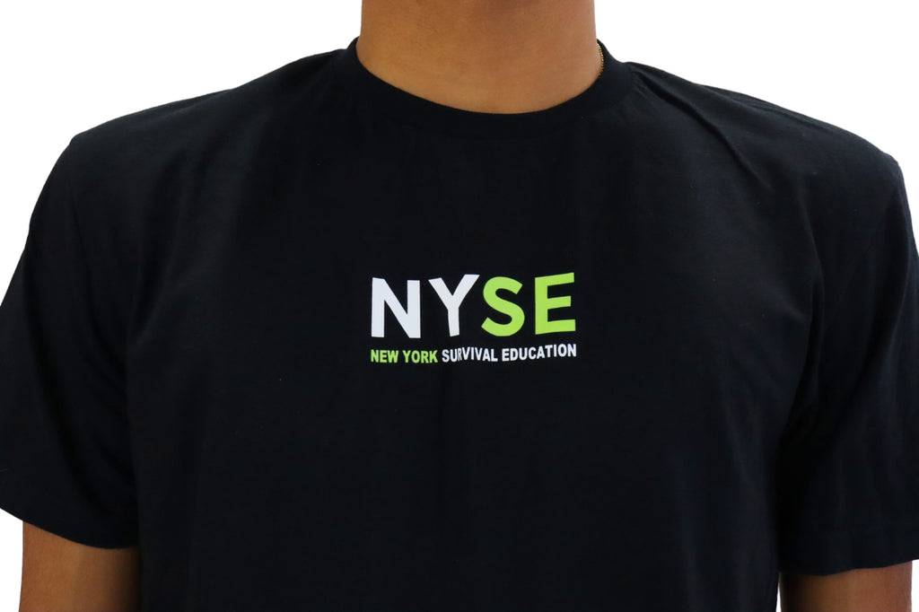 Close Up of front view of a model wearing a black t-shirt. On the left chest is a small logo in green and white that reads 'NYSE' with the full text 'New York Survival Education' printed below it.