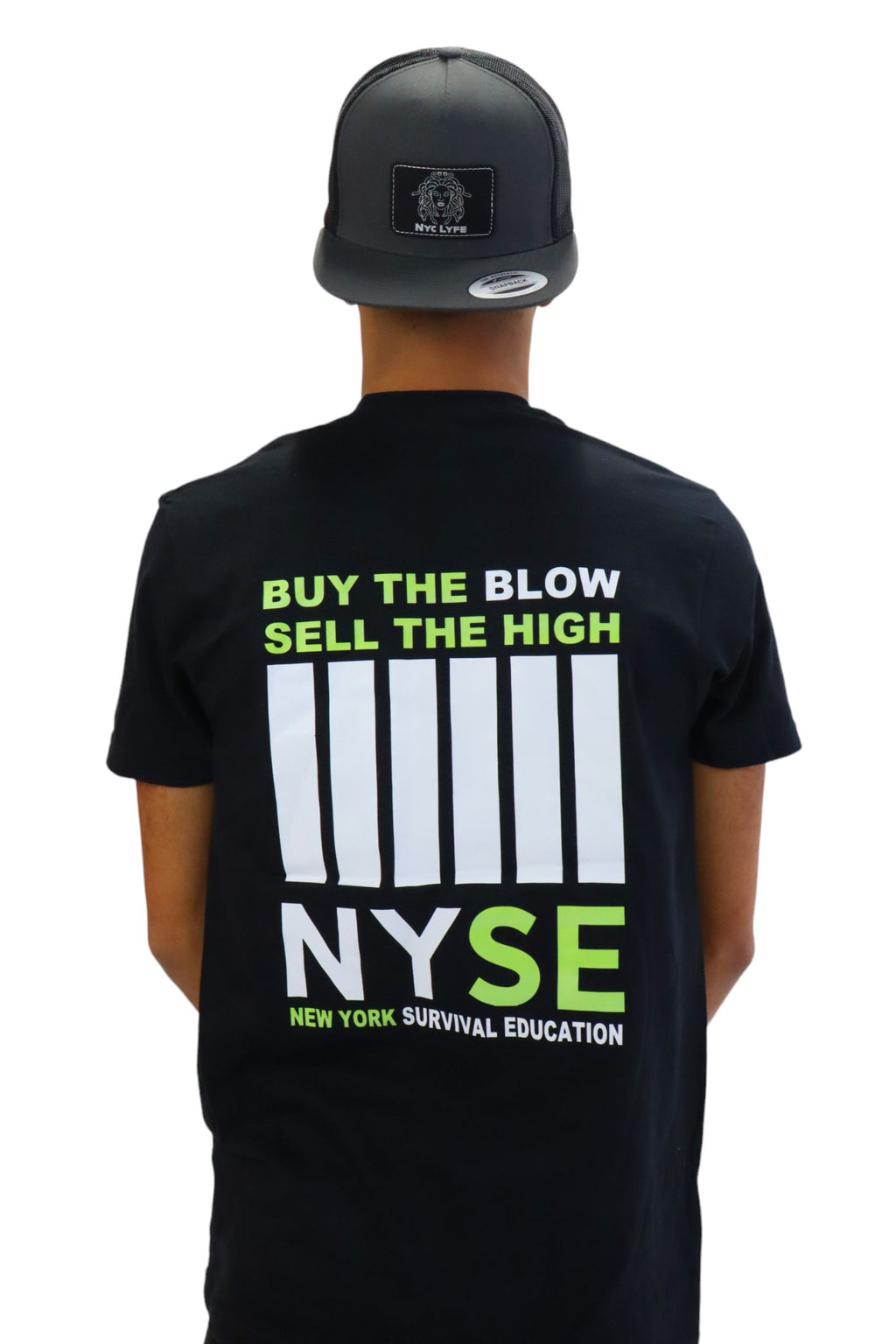 Back view of a model wearing a black t-shirt with a large graphic. In neon green text it reads 'BUY THE BLOW SELL THE HIGH' above a stylized white bar code and the acronym 'NYSE', which stands for 'New York Survival Education'.